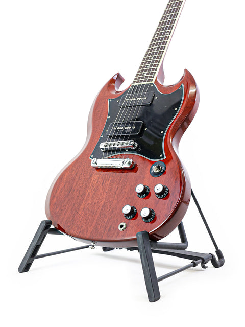 Elegant Gibson SG Classic guitar displayed on a stand, highlighting its craftsmanship with a pristine white backdrop.
