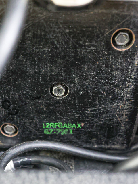  Engine compartment of a 1979 Mesa Boogie Mark IIA Combo car, featuring a prominent green sticker on the surface.