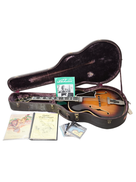 Featuring a 1966 Gibson Johnny Smith guitar, a case, and a CD, illustrating the rich history of American guitar craftsmanship.