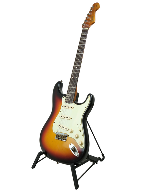 Fender Custom Shop '60 Stratocaster Hardtail on a stand, highlighted by a simple white background for a classic look.