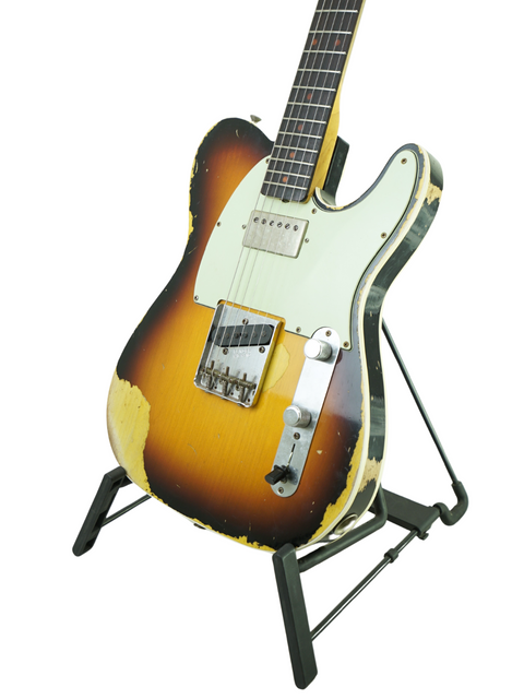 Fender Custom Shop 60s Telecaster displayed on a stand, featuring a heavy relic design against a white backdrop.
