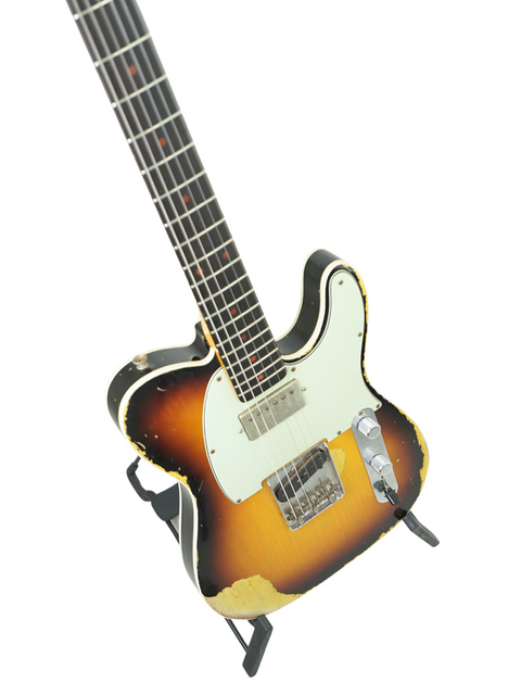 Fender Custom Shop 60s Telecaster in sunburst finish on a stand, emphasizing its heavy relic craftsmanship from 2017.
