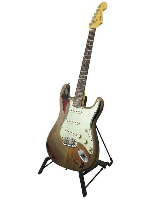 Fender Custom Shop Rory Gallagher Stratocaster, featuring a wooden body, displayed on a sturdy metal stand.
