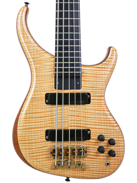 Full angled view of the Alembic Orion 5-string bass guitar on a stand, displaying its natural wood finish and stylish profile.