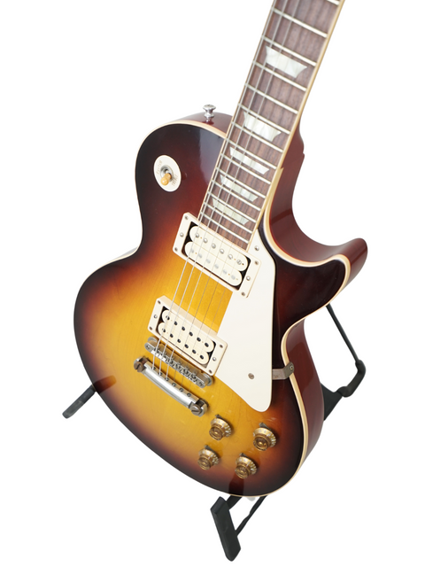Gibson Custom LPR-8 '58 Les Paul Standard R/I guitar with a sunburst finish, elegantly resting on a stand.
