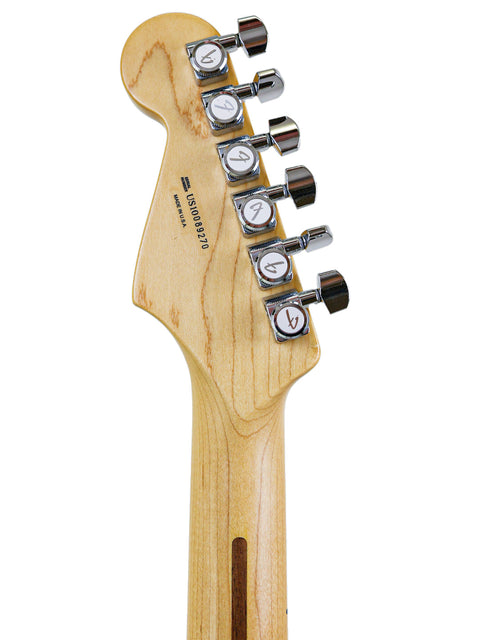 Head of a guitar showing tuning pegs and a wood grain texture, isolated on white background.