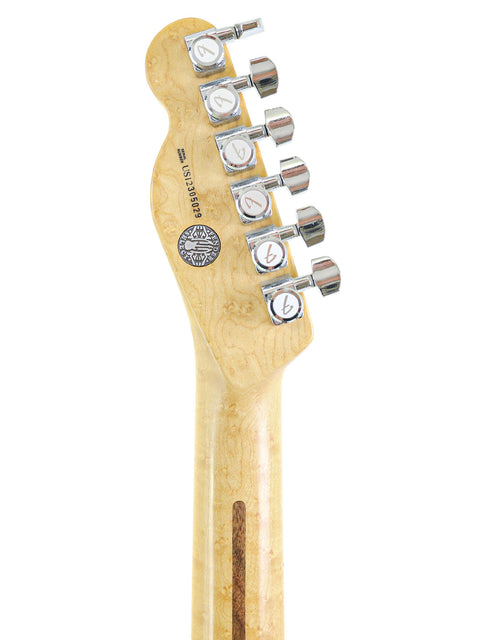 Headstock of a guitar with tuning pegs on a white background.