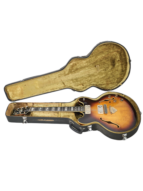Inside a guitar case lies a 1979 vintage Ibanez Artist 2630, showcasing its stunning sunburst design.
