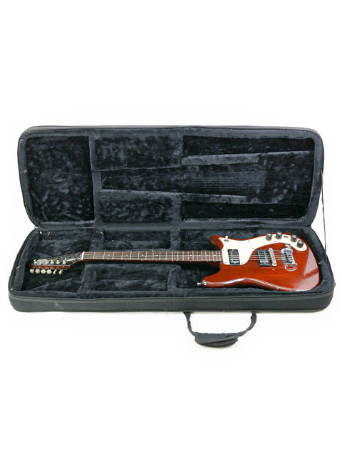 Inside a red and black guitar case lies a vintage 1966 Epiphone Wilshire, a true gem for music lovers.
