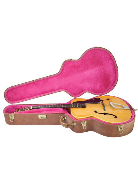 Inside a vibrant pink case lies a vintage Vega C-66 guitar, a classic piece from the USA, dating back to 1940.