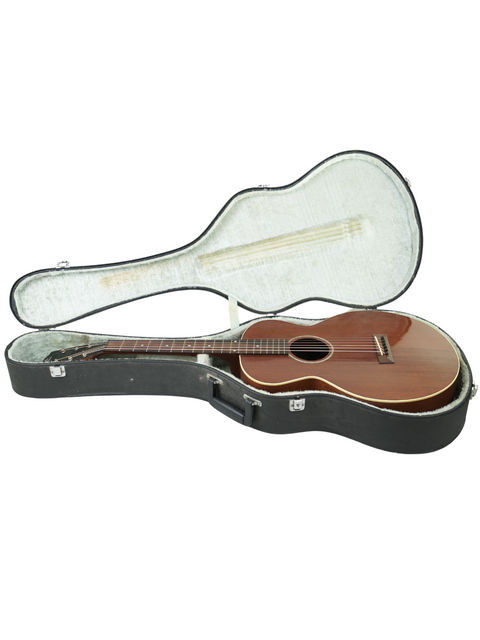 Inside a wooden guitar case lies a vintage 1929 Gibson L-0, highlighting its historical significance and elegant structure.
