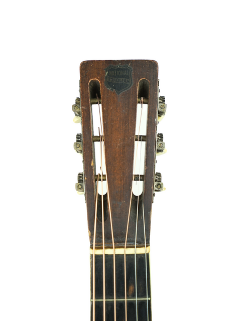 Martin Luther King Jr. in 1940, strumming a National Triolian acoustic guitar from the 1930s, a piece of vintage Americana.
