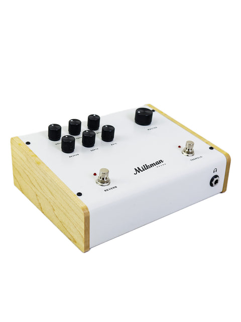 Milkman 'The Amp' pedalboard in white and wood, showcasing four knobs for sound control.
