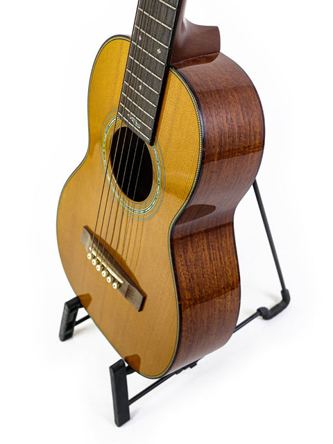 Mini Signature Edition Martin Sting guitar on a stand against a white background, #35 of 100, signed by Sting, USA 2005.