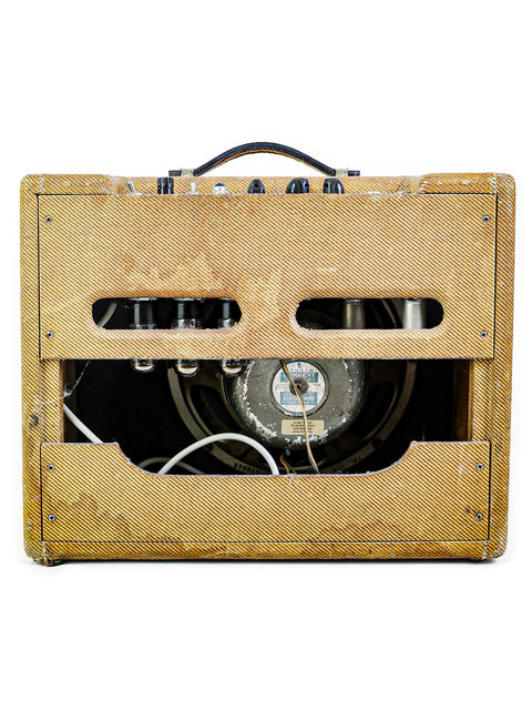 Old-school 1959 Fender Tweed Deluxe 5E3 guitar amp with wires and speaker, a timeless piece of music history.