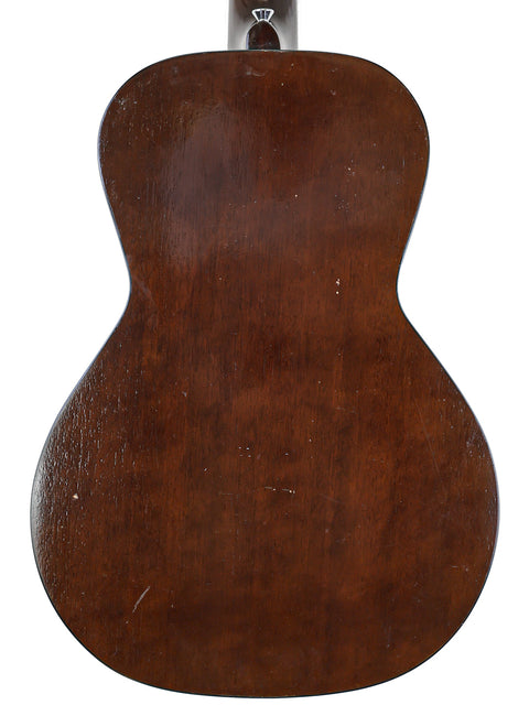 Rear perspective of a 1930s Gibson J-45, highlighting its classic design and rich wood grain.