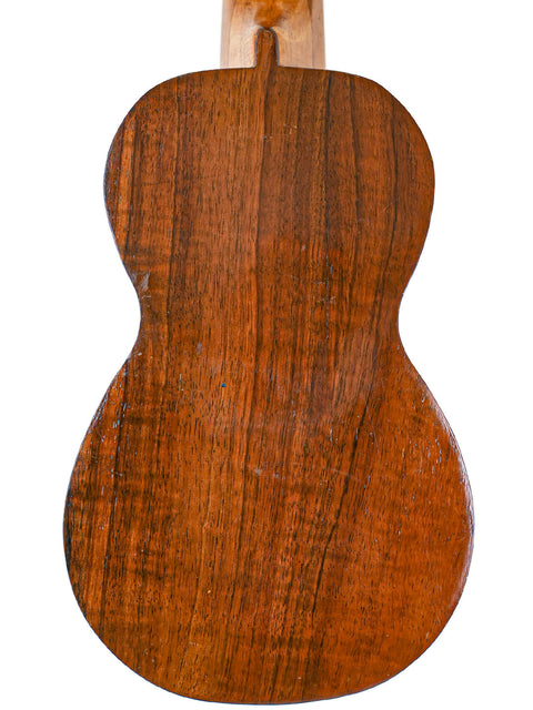 Rear view of the Aloha Tabu Akai ukulele body, highlighting the smooth wooden back and vintage finish.

