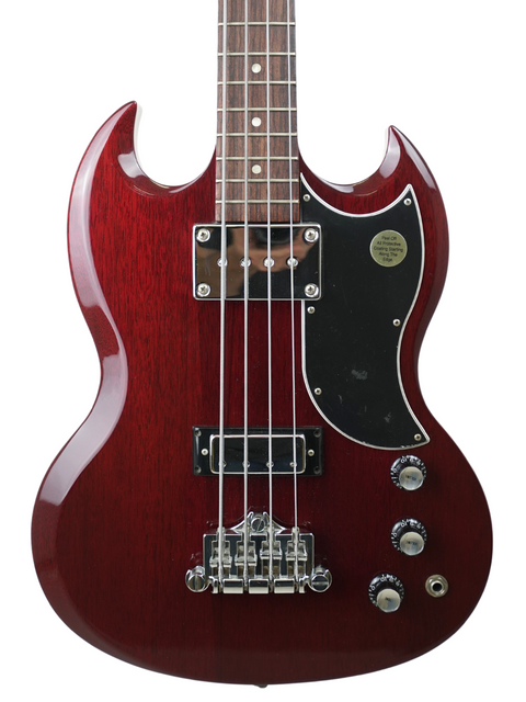Red electric bass guitar with a sleek black pick guard, perfect for musicians seeking quality and style.