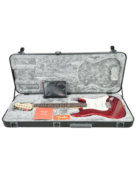 Red electric guitar in its case with a small pouch and label.