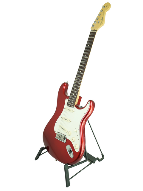 Red electric guitar on a black stand against a white background.