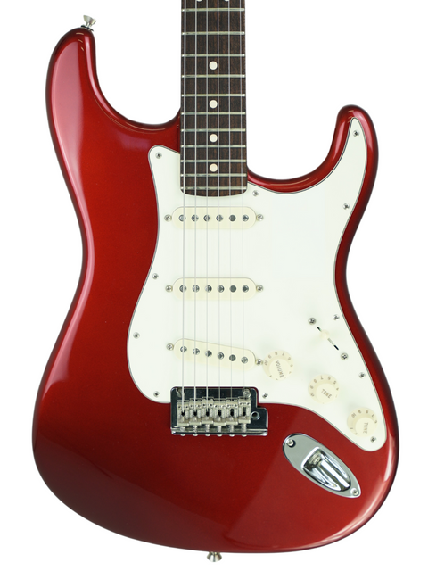 Red electric guitar with white pickguard on a white background.