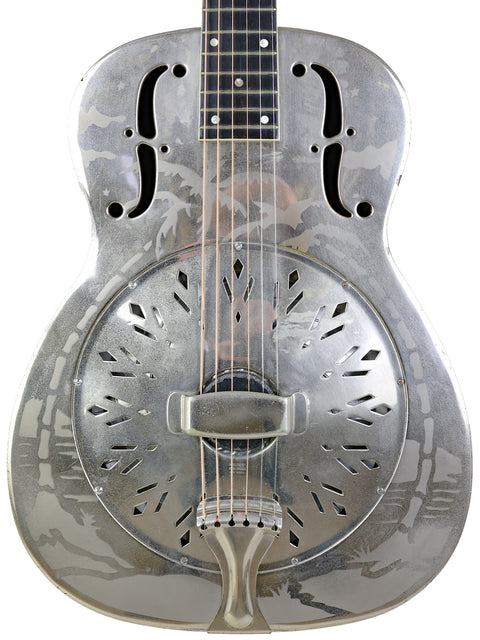 Silver 1934 National Style 'O' guitar featuring a black pick guard, highlighting its vintage charm and unique design.