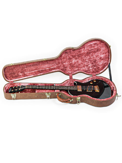 Sleek black guitar case featuring vibrant red lining, ideal for your Gibson Nighthawk - USA 1999. Elevate your gear today!

