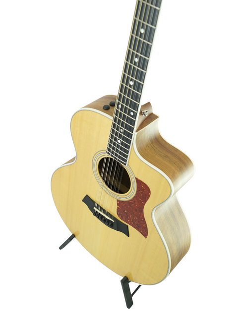 Stunning Taylor 812ce acoustic guitar, featuring a sleek body and rich sound, ideal for any musician's collection.