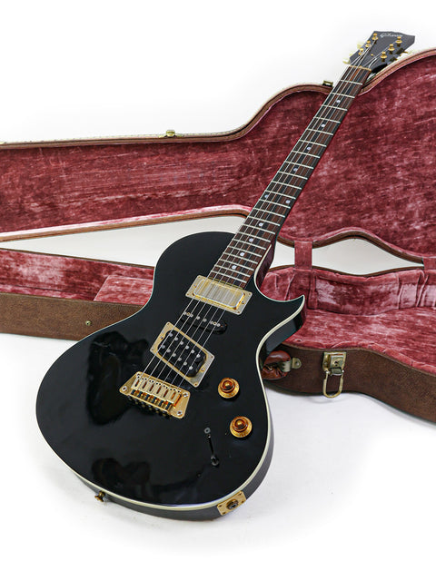 Stunning black electric guitar, Gibson Nighthawk 1999 model, securely housed in a case for ultimate protection and portability.