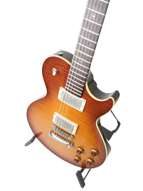 Sunburst electric guitar on a stand, isolated on a white background.