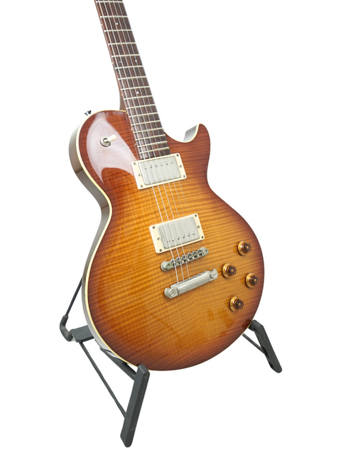 Sunburst electric guitar with dual pickups on a stand, isolated on a white background.