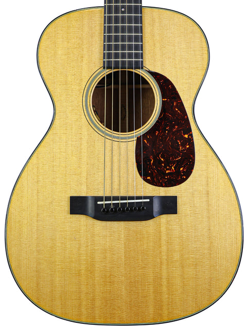 The Martin 0-18 acoustic guitar, made in the USA in 2021, features a classic design with rich wood tones and fine detailing.
