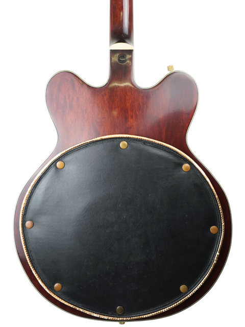 The rear of a 1967 Gretsch 6122 guitar, adorned with a sleek black leather cover, showcasing its vintage appeal.