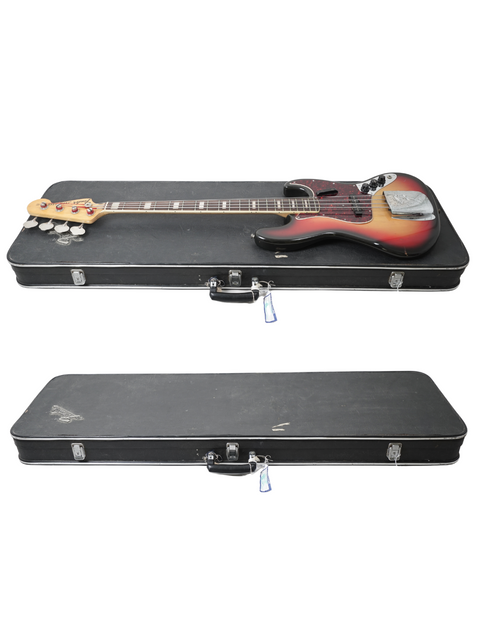Two classic 1972 Fender Jazz Basses neatly placed in a case, set against a white backdrop.
