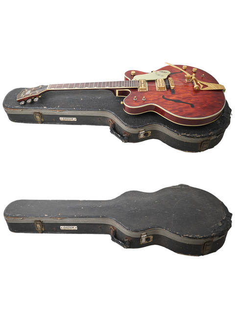 Two guitars, including a vintage 1967 Gretsch 6122, displayed in an open case, showcasing their classic design.