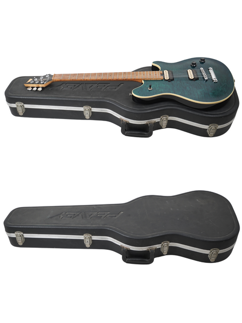 Two guitars, one with a green body, nestled in a black case labeled Peavey EVH Wolfgang Standard Hardtail – USA 2000.
