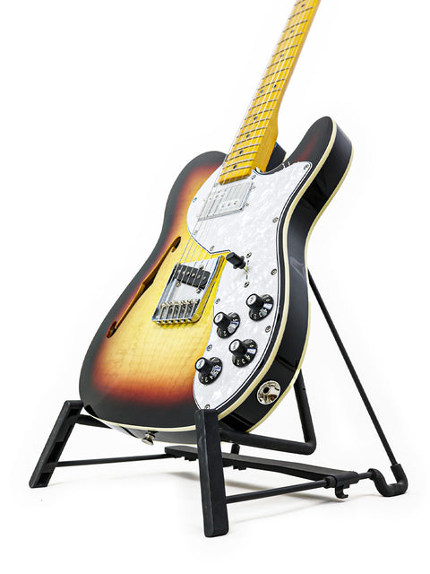  Txxx Custom Thinline '72 Partscaster guitar displayed on a stand with a bright white backdrop.