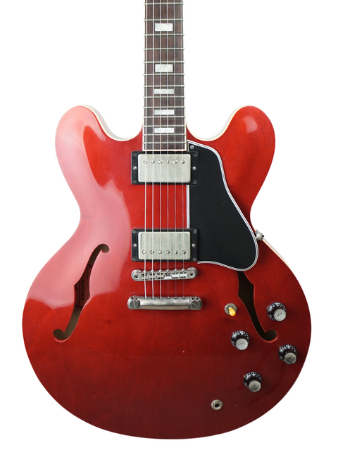 Vibrant red guitar with a stylish black body and white pickguard, a must-have for any guitarist looking to stand out.
