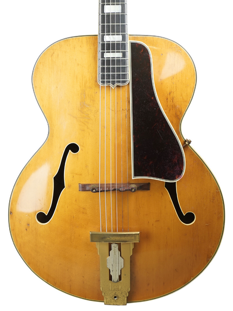 Vintage 1939 Gibson L-5 guitar in yellow with a sleek black pickup, showcasing classic design and craftsmanship.