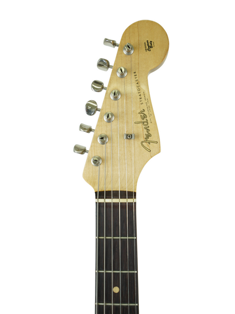 Vintage 1961 Fender Stratocaster guitar in close-up, set against a minimalist white background, emphasizing its craftsmanship.