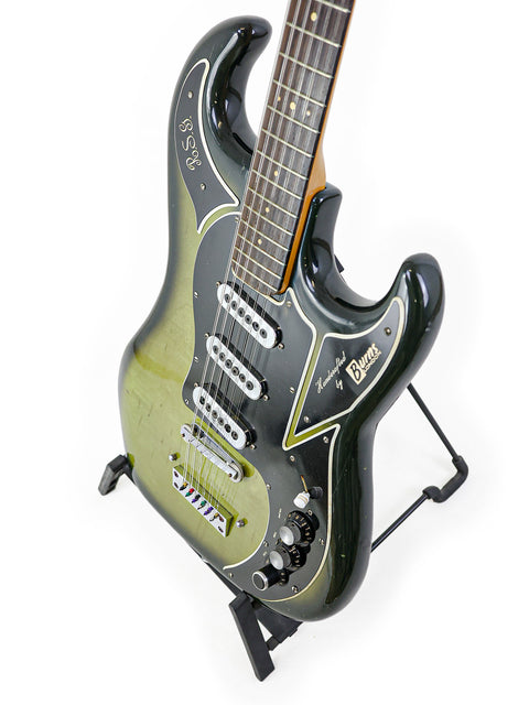 Vintage 1964 Burns Double Six 12-string guitar, highlighted by a green neck, black body, and a crisp white pickguard.
