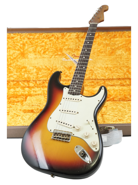 Vintage '67 sunburst Fender Stratocaster, highlighting its iconic shape and finish, crafted by Fender Custom Shop in 2022.