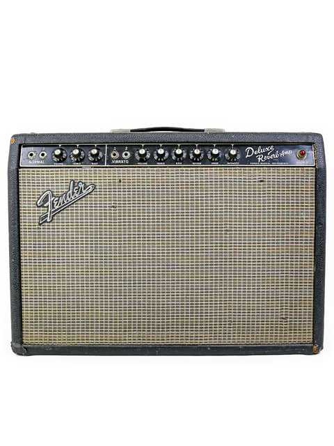 Vintage Fender Deluxe Reverb amp on a black and white checkered background, showcasing its classic 1965 design.