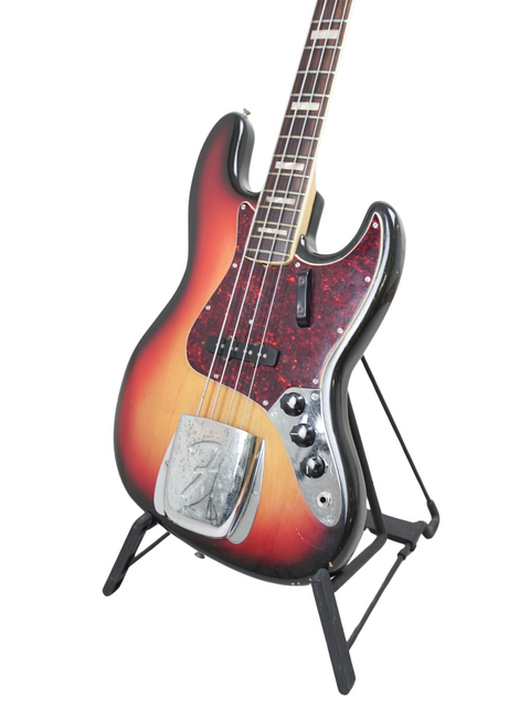 Vintage Fender Jazz Bass from 1972 on a stand, emphasizing its unique style and historical significance.