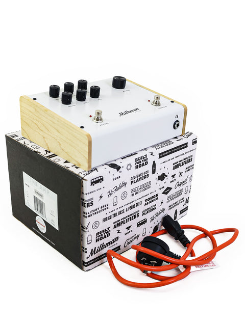 White and black Milkman 'The Amp' box with a black and white pedal displayed next to it.
