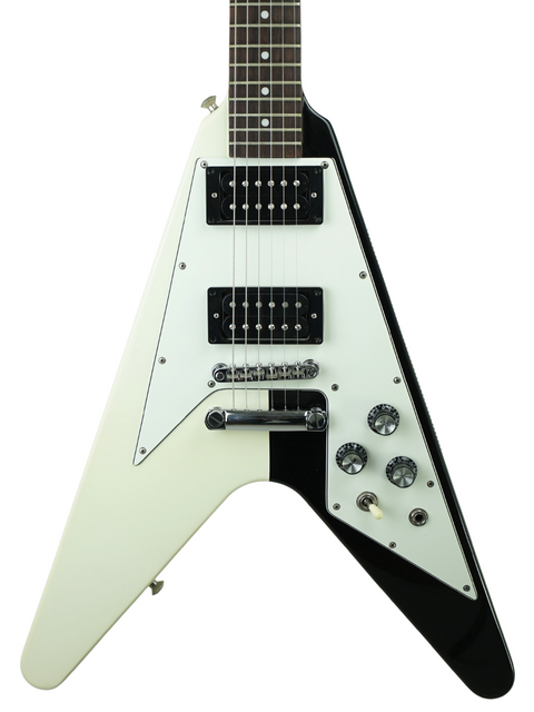White and black flying V electric guitar against a white background.
