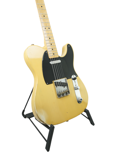 Yellow electric guitar on a stand, showcasing the 1998 Fender Custom Shop Cunetto Nocaster Relic model.

