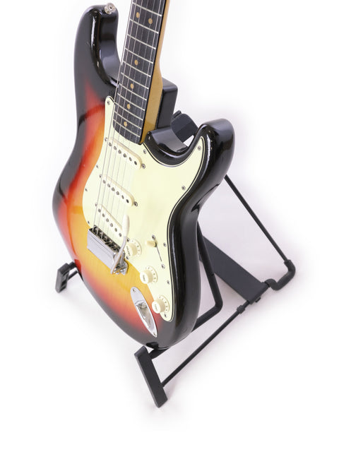 1964 Vintage Fender L Series Stratocaster in Fiesta Red resting on a stand, set against a white background.