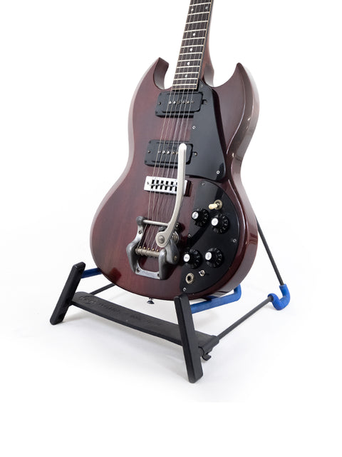 1972 Gibson SG Pro guitar elegantly positioned on a blue stand, showcasing its vintage charm and design.