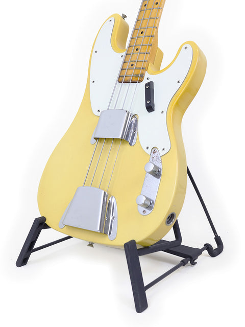 A 1968 USA Fender Telecaster Bass in yellow, resting on a stand.